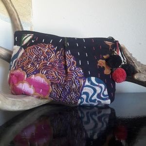 Cosmetic bag with pompoms